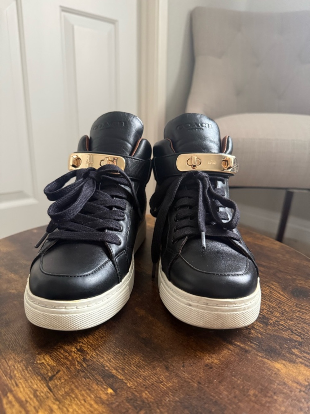 Coach Black Leather High-Top Sneakers with Gold Accents